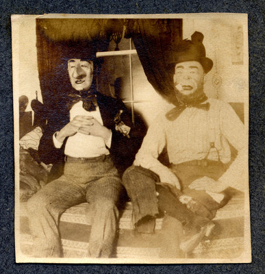 Photograph of two seated clowns
