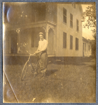 Photograph of a man with a bicycle