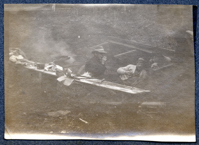 Photograph of unidentified men sitting outside