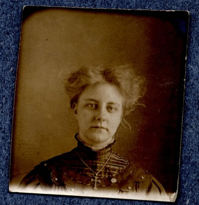 Photograph of a woman in a high-necked dress