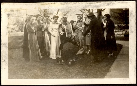 Photograph of group of women and a man and woman dressed as a king and queen