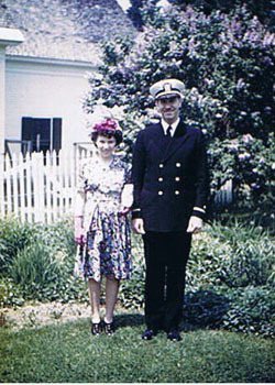 Bettie with her husband Merritt standing outside a house