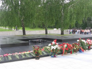 One in four died in Belarus in the Great Patriotic War.   The three trees symbolize the living.   The flame represents the missing.  