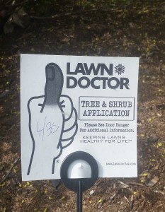 A sign for "Lawn Doctor" with a hand giving the thumb's up sign. The thumb is colored black